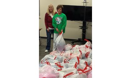 School employees prepare gifts for homeless students
